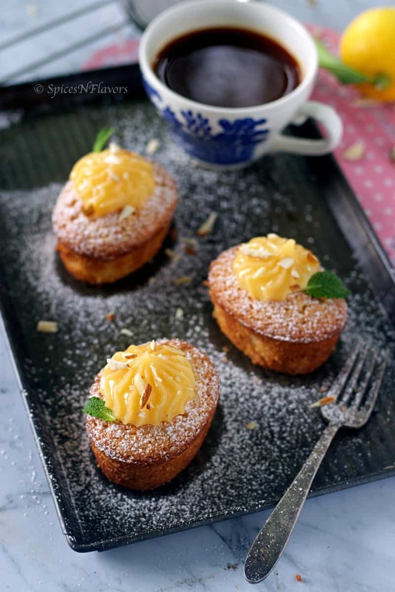 close up image of lemon friands with lemon curd on top