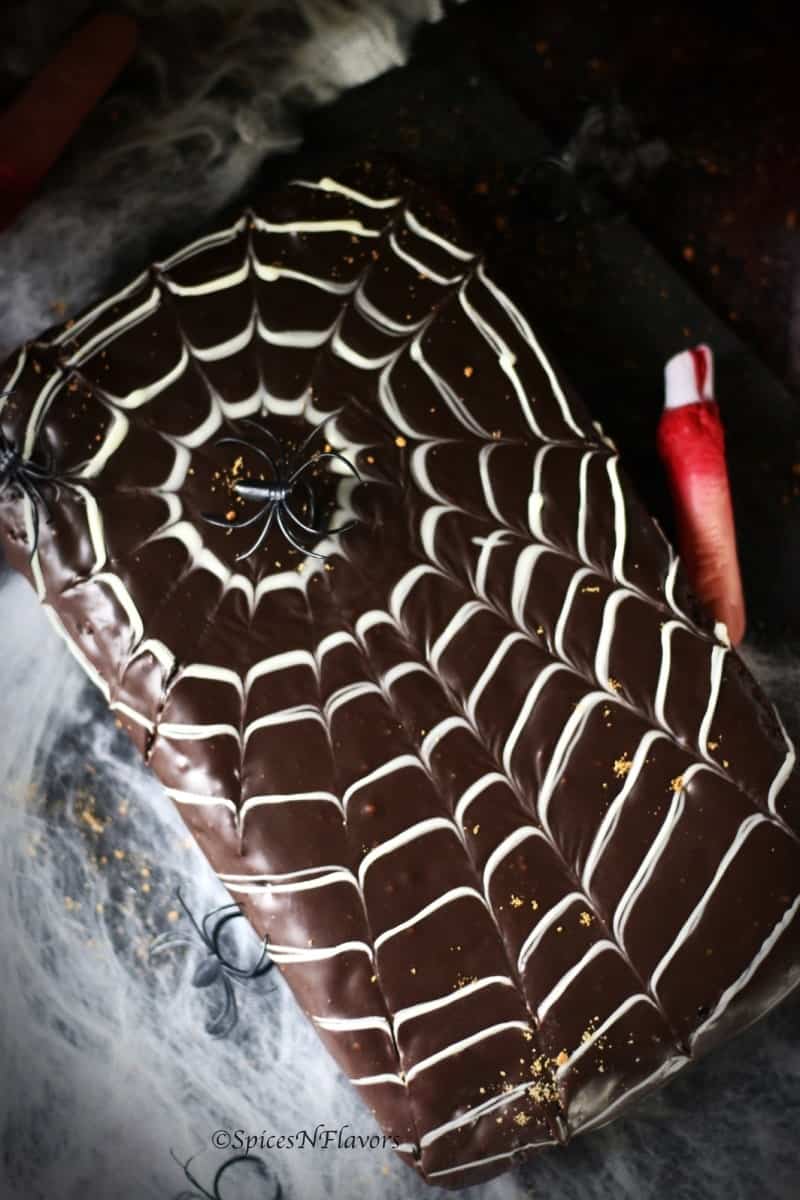 vertical image of easy halloween spider web cake