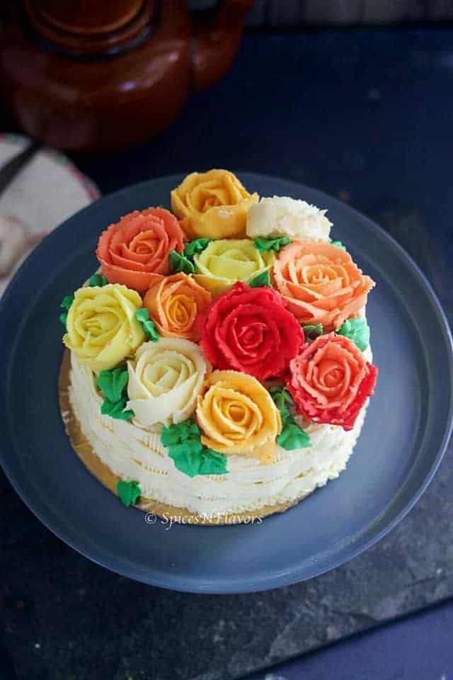 Basket weave cake adorned with buttercream roses made using best buttercream frosting