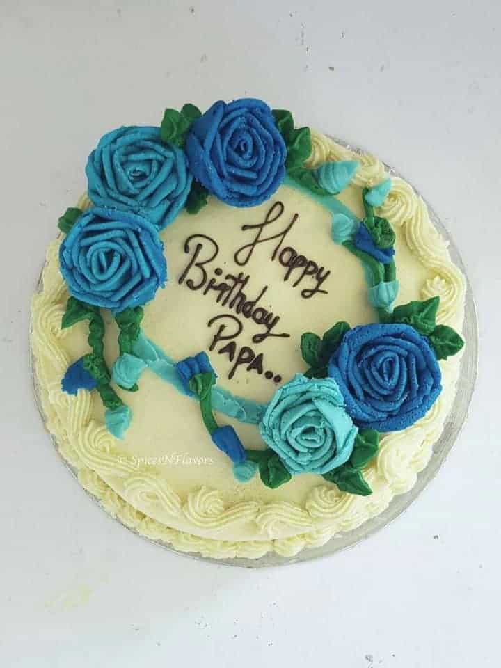 a cake adorned with buttercream roses and frosted with best buttercream frosting