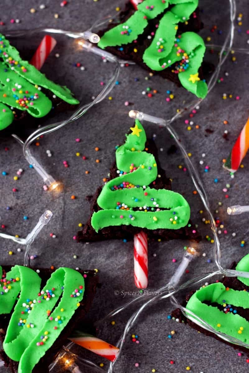 triangle shaped brownies decorated as Christmas tree using buttercream 