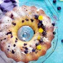 vertical image of blueberry lemon pound cake showing the entire baked cake