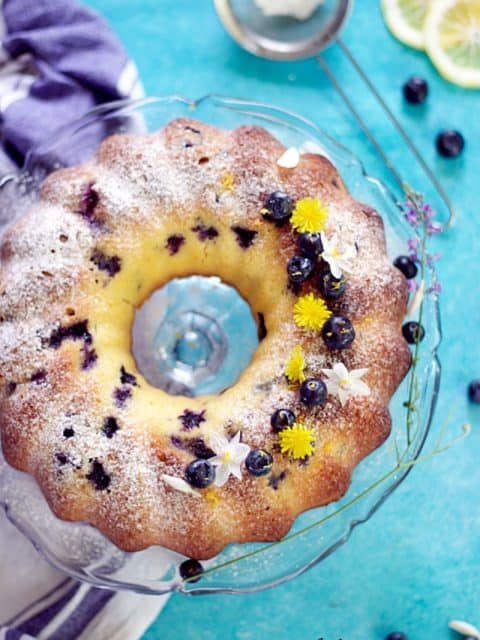 vertical image of blueberry lemon pound cake showing the entire baked cake