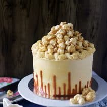 eggless chocolate caramel cake with upside down caramel drip and topped with popcorn