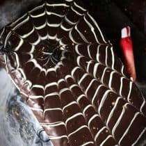 vertical image of easy halloween spider web cake