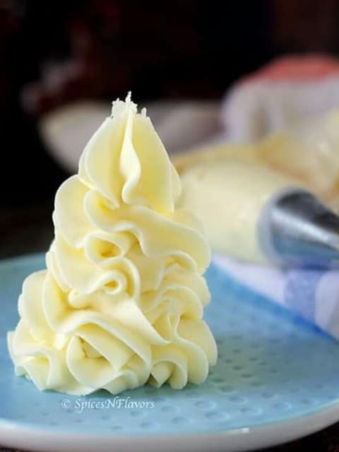 Best Buttercream Frosting piped on a plate to show the smooth and soft texture