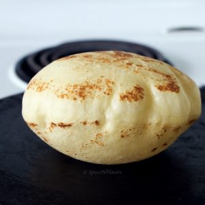 puffed up image of pita bread cooked on stovetop