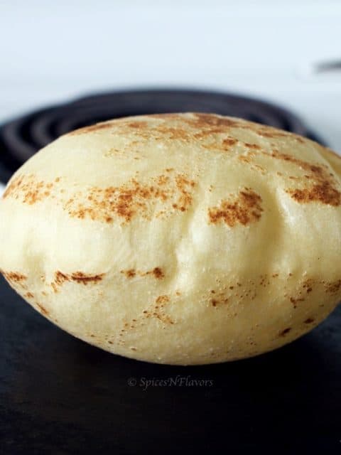 puffed up image of pita bread cooked on stovetop