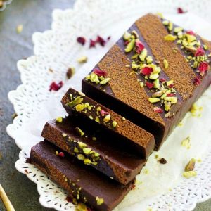 block of instant pot chocolate terrine with slices placed on a white oval plate