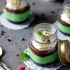 instant pot mint cheesecake jars placed in a way showing the layers of the dessert