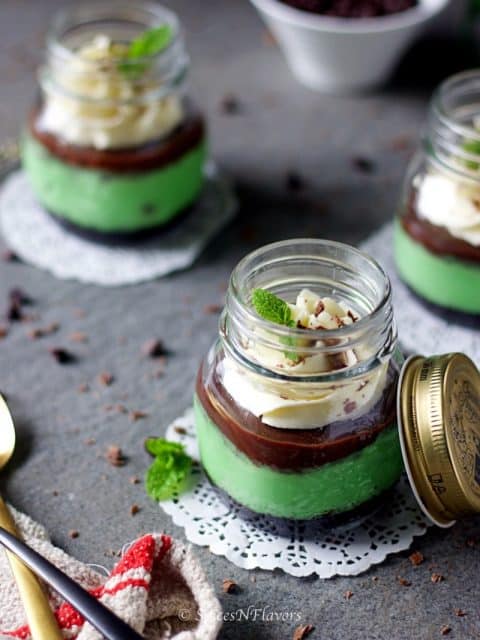 instant pot mint cheesecake jars placed in a way showing the layers of the dessert