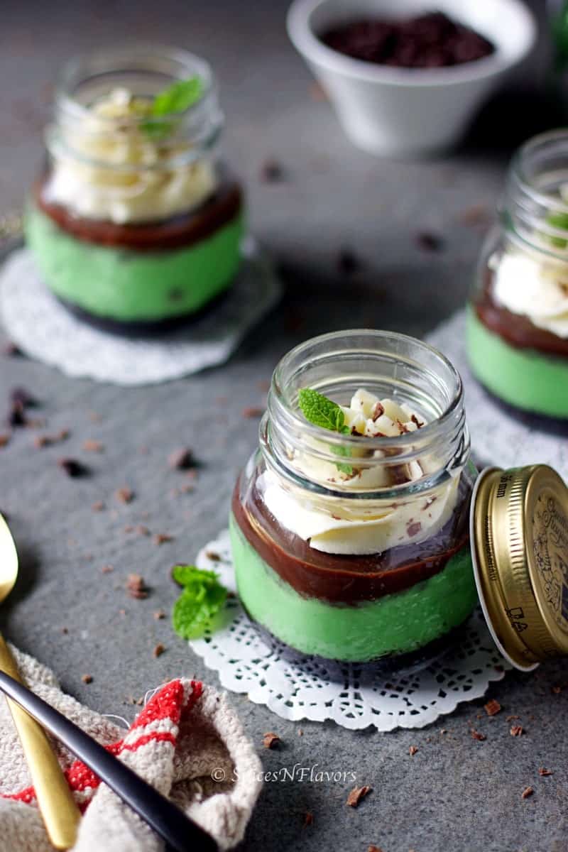 instant pot mint cheesecake jars placed in a way showing the layers of the dessert