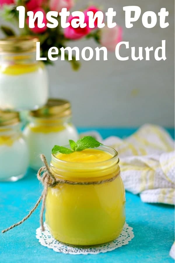 straight image of instant pot lemon curd with yogurt jars and flowers in background