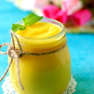 close up image of instant pot lemon curd with mint leaf garnish