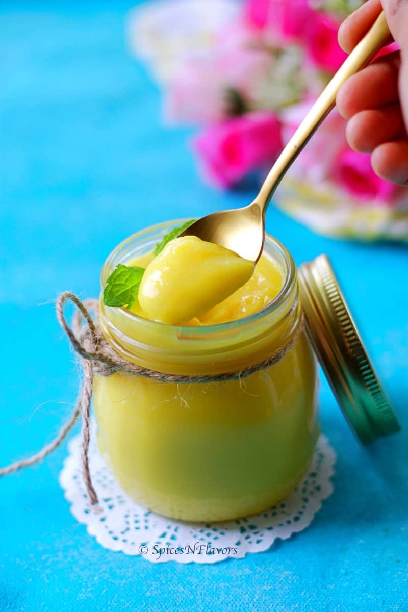 instant pot lemon curd spooned out to show the smooth texture