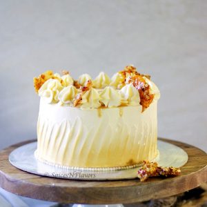 straight image of whole butterscotch cake placed on a cake board and stand