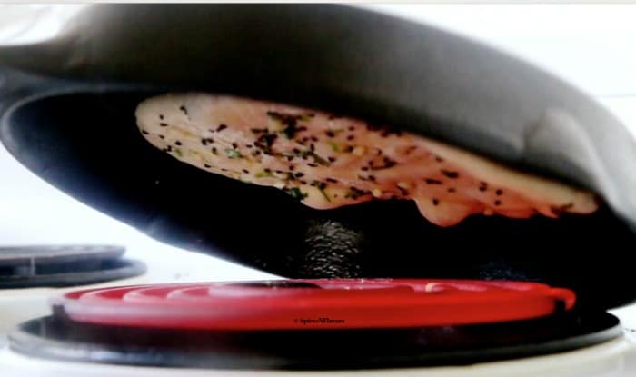 naan bread being directly cooked on the flame