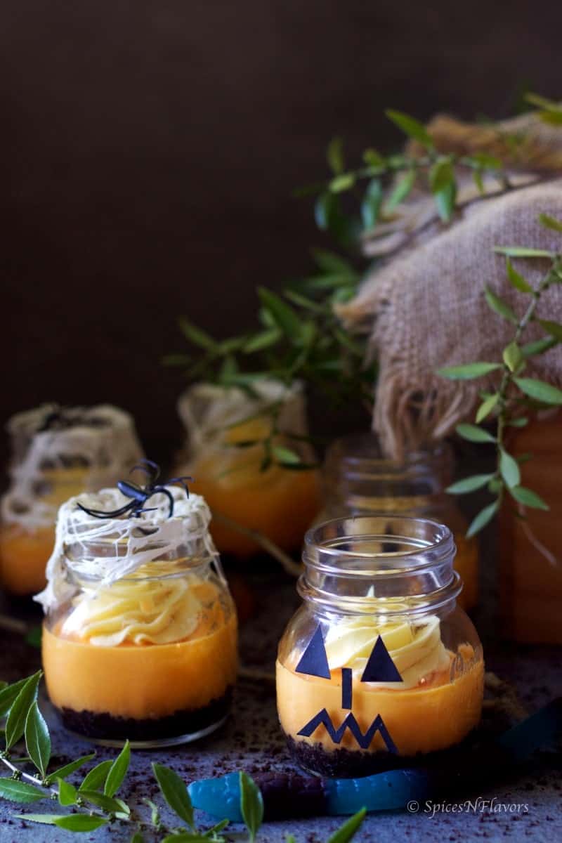 instant pot pumpkin cheesecake in jars decorated as spiderweb and monster jars for Halloween 