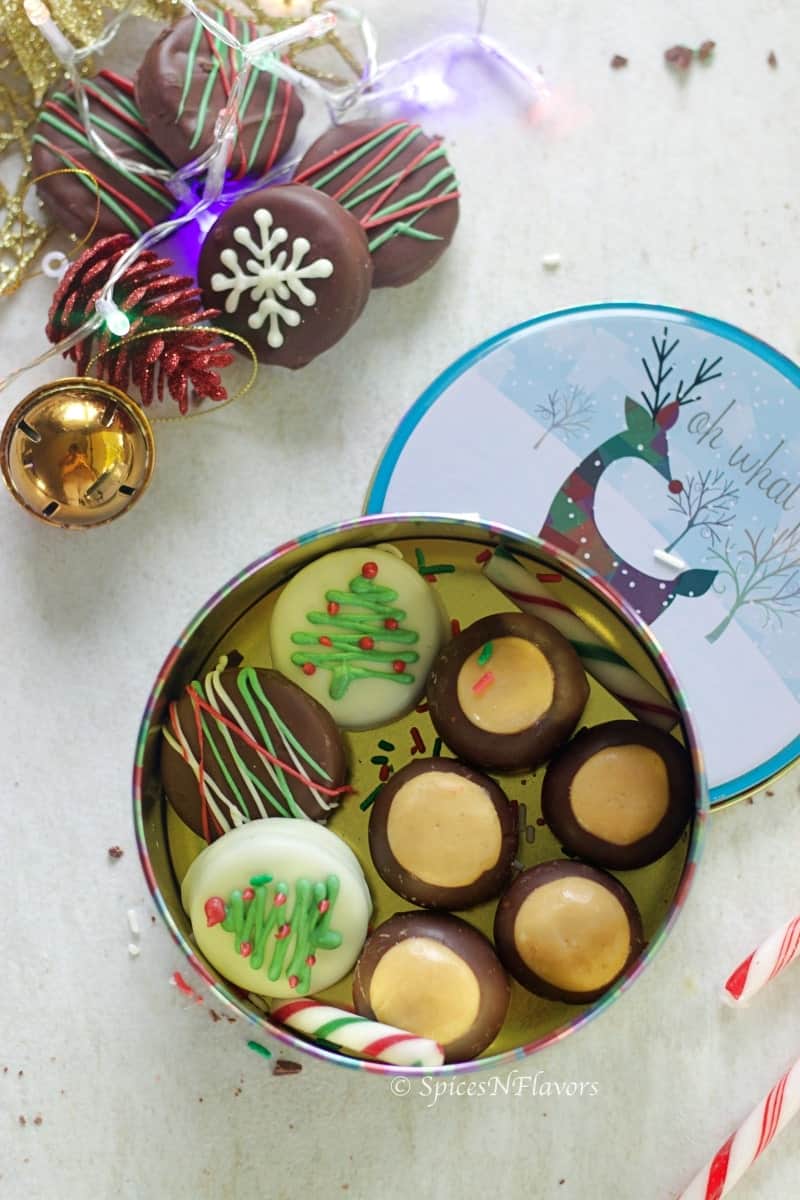 buckeyes and chocolate covered oreos placed in a cookie tin