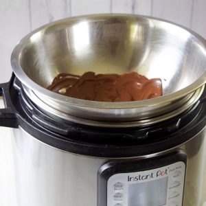 dark chocolate melted in a metal bowl over instant pot