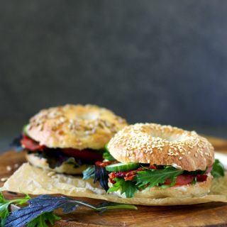 bagel sandwiches placed on a wooden serving board