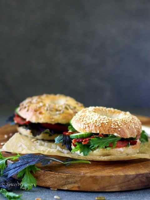 bagel sandwiches placed on a wooden serving board