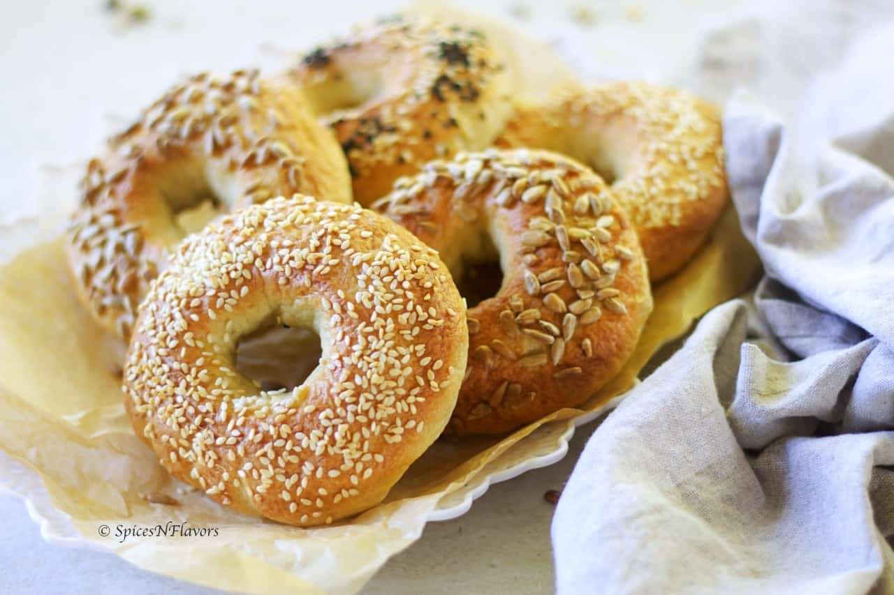 5 bagels placed in a line on a parchment paper