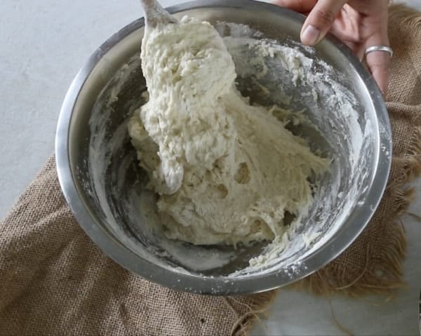 combining the ingredients together until it comes together as a dough