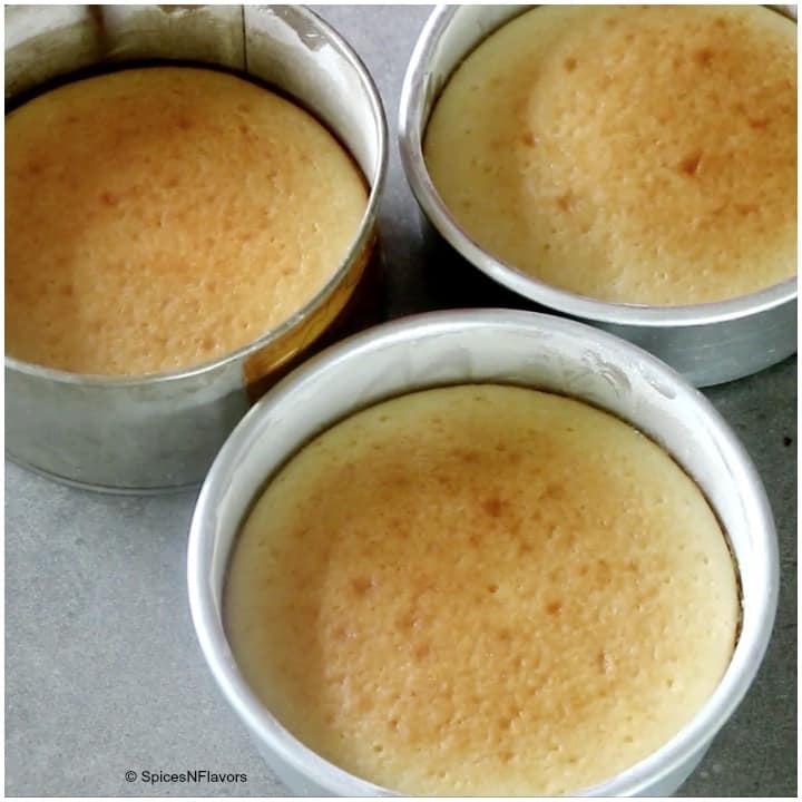 three eggless cake baked in three different cake pans straight from the oven