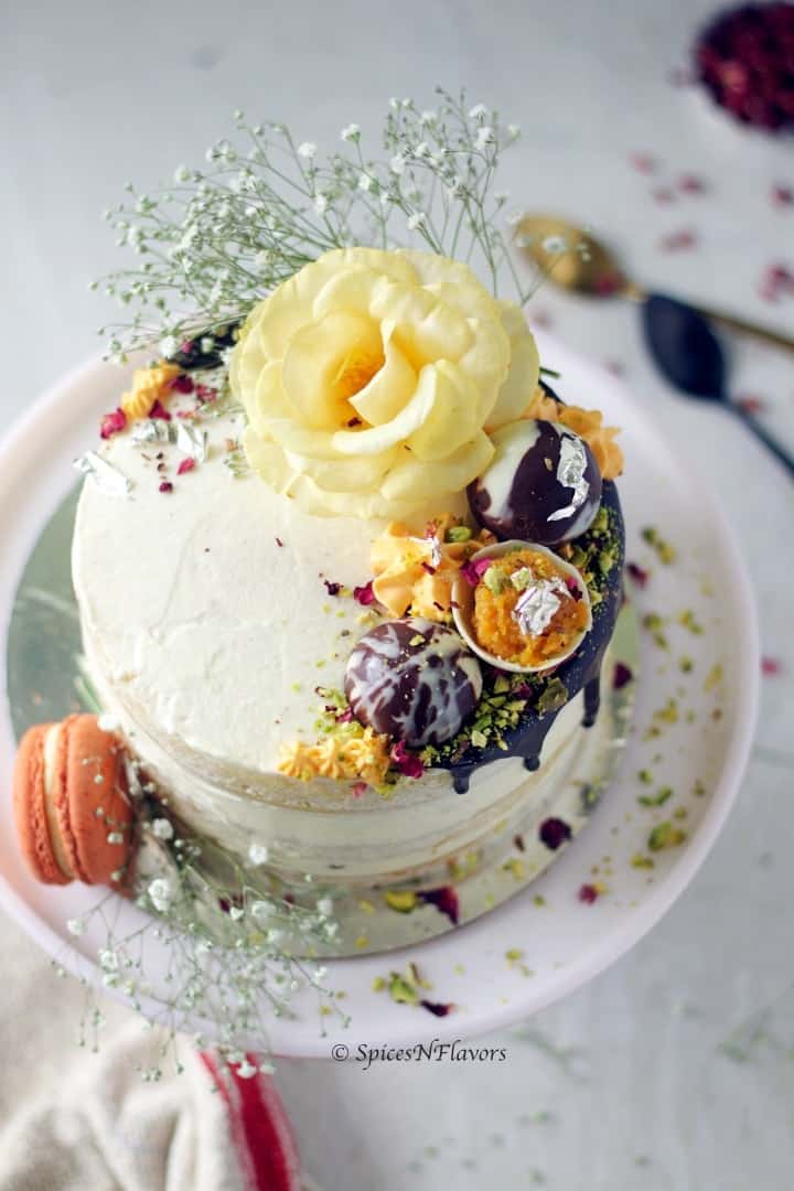 top view of the gajar halwa cake showing the decoration made of flowers, chocolate and macarons