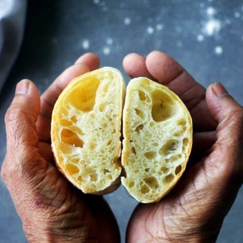 ciabatta bread with open crumbs held in between the palms