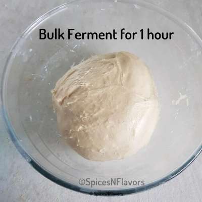 bread dough placed in a glass bowl for bulk fermentation