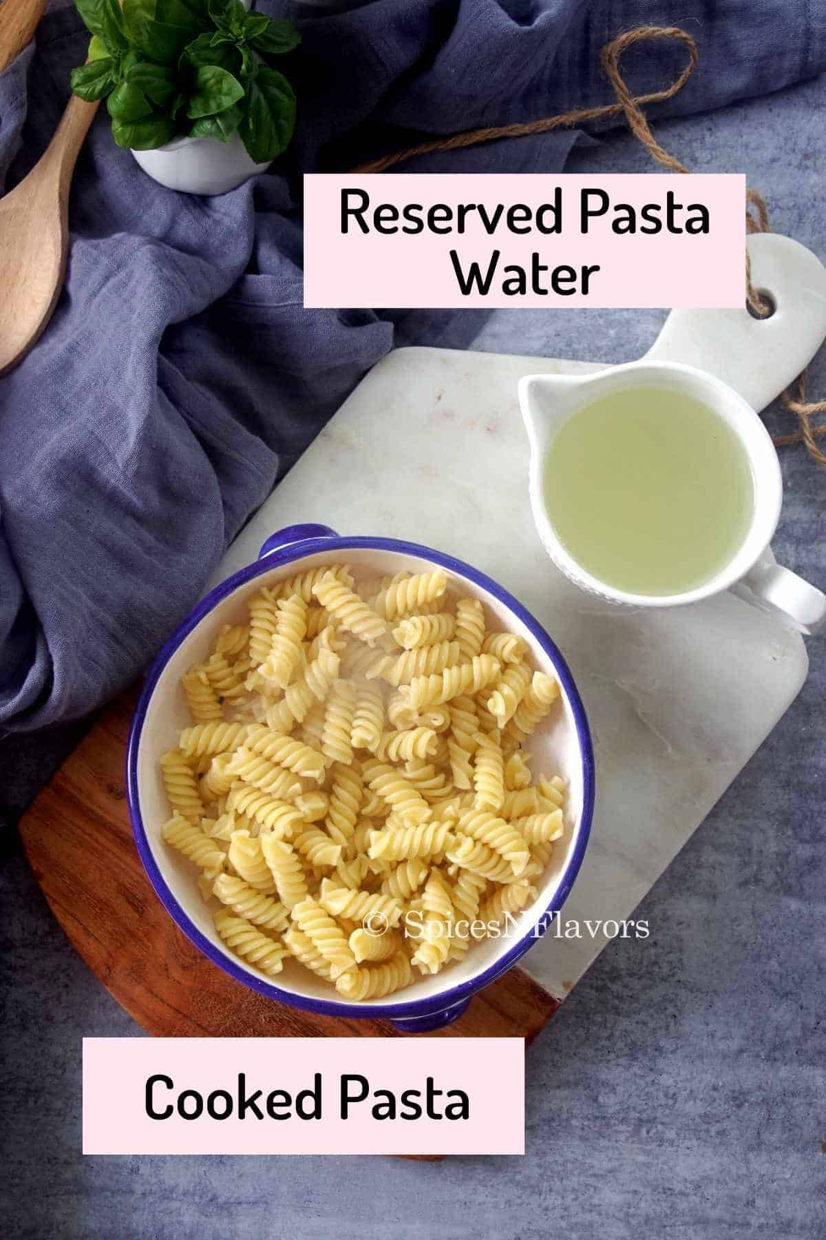 cooked pasta and pasta water placed on a marble chopping board