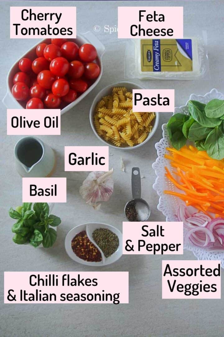 ingredients needed to make the tiktok pasta all neatly placed on a white tile