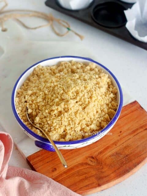 crumble topping placed in a white and blue bowl on a marble board