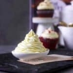 cropped up image of the frosting piped on a small bowl to fit the recipe card size