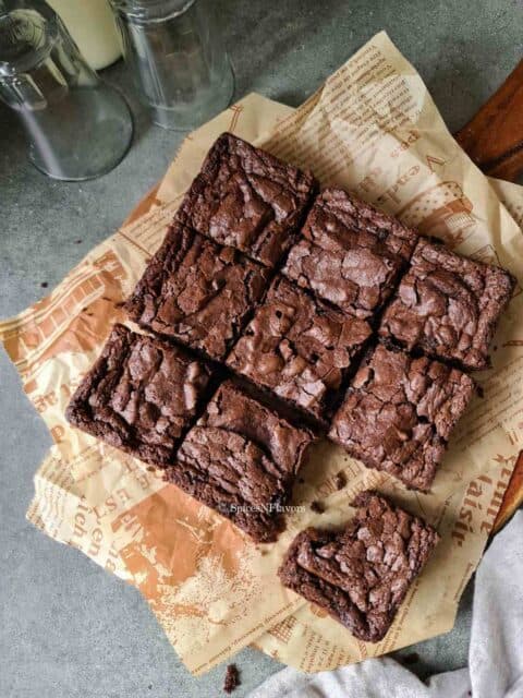 brownie square pieces placed on a brown parchment paper.