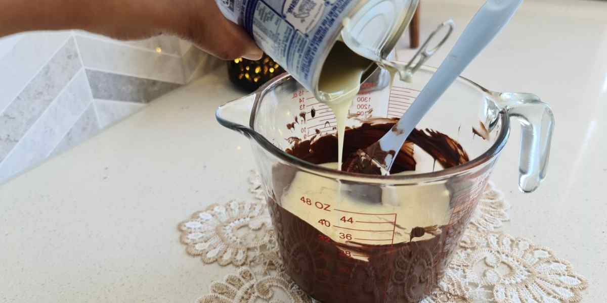 combining melted chocolate with condensed milk