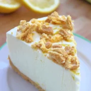 slice of no bake lemon oreo cheesecake placed on a white plate