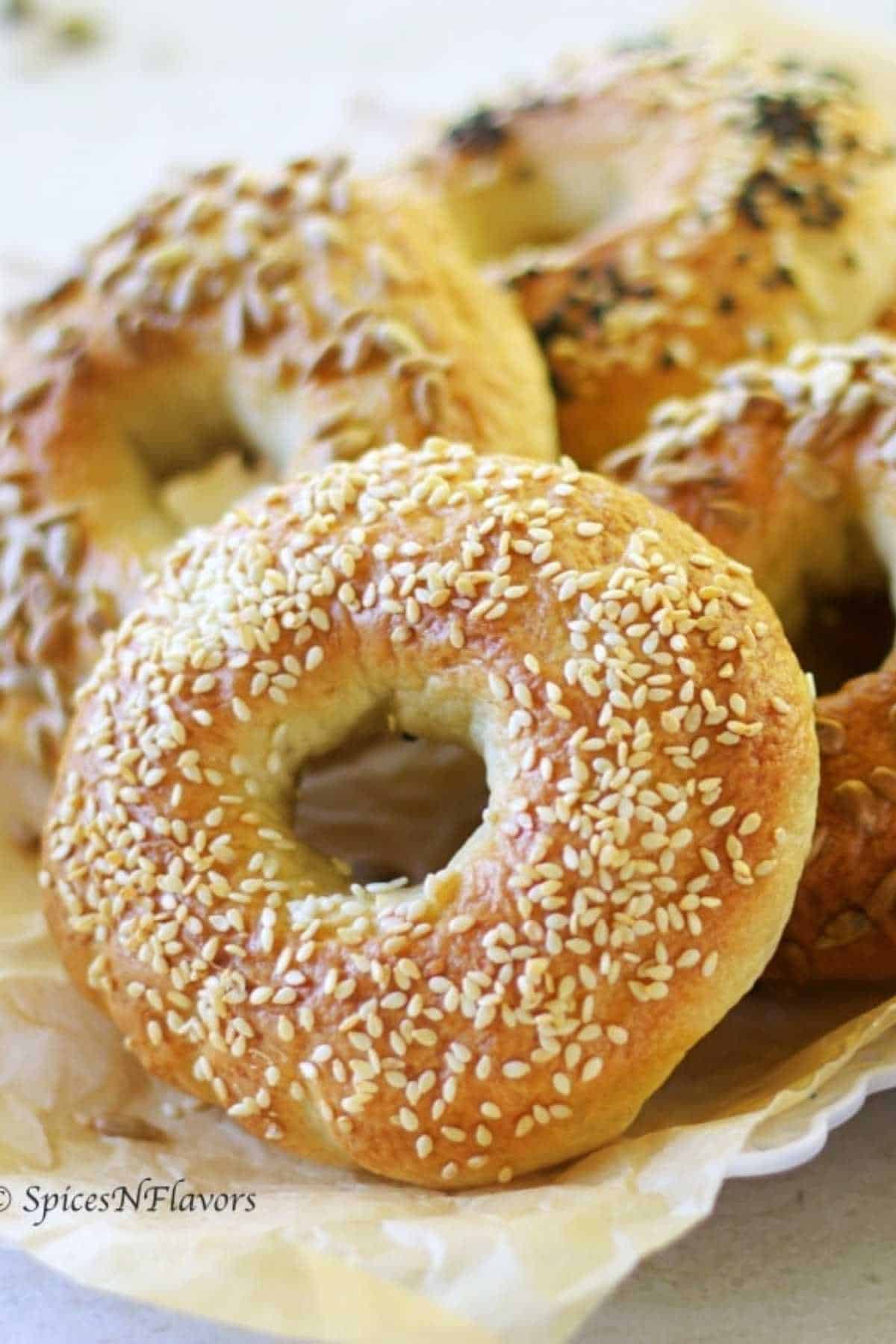 four bagels placed on a brown parchment paper 