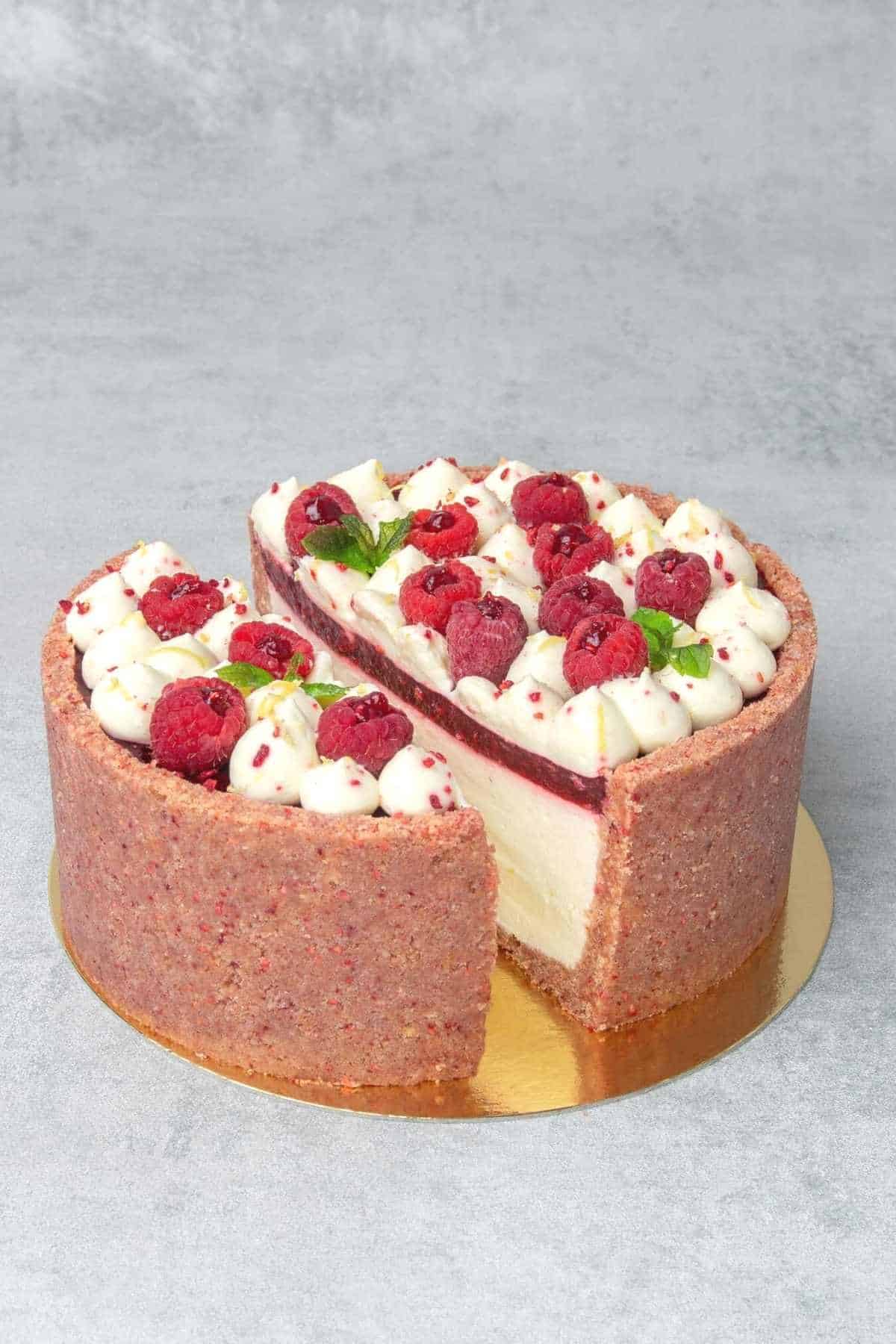 no bake raspberry cheesecake sliced in the middle to reveal the layers from inside