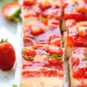 strawberry and rhubarb cheesecake bars placed behind one another