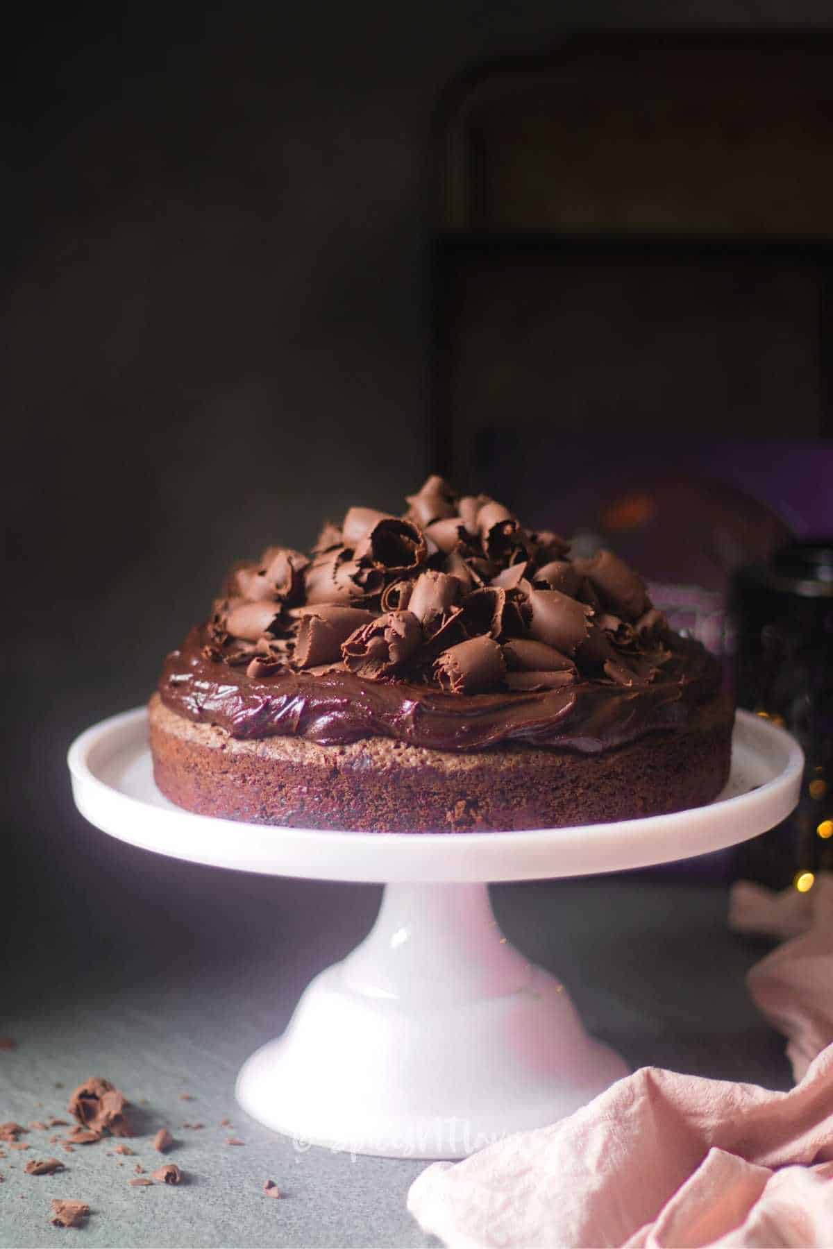 https://spicesnflavors.com/wp-content/uploads/2022/09/chocolate-cake-with-ganache-and-chocolate-curls.jpg