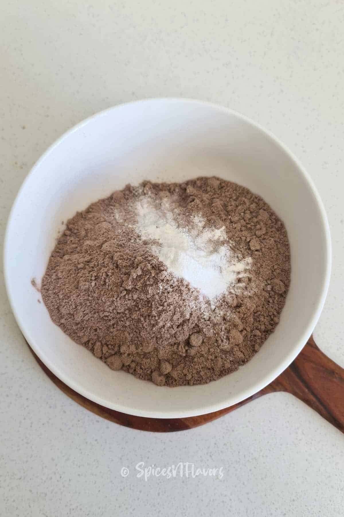 dry ingredients from brownie box emptied into white bowl