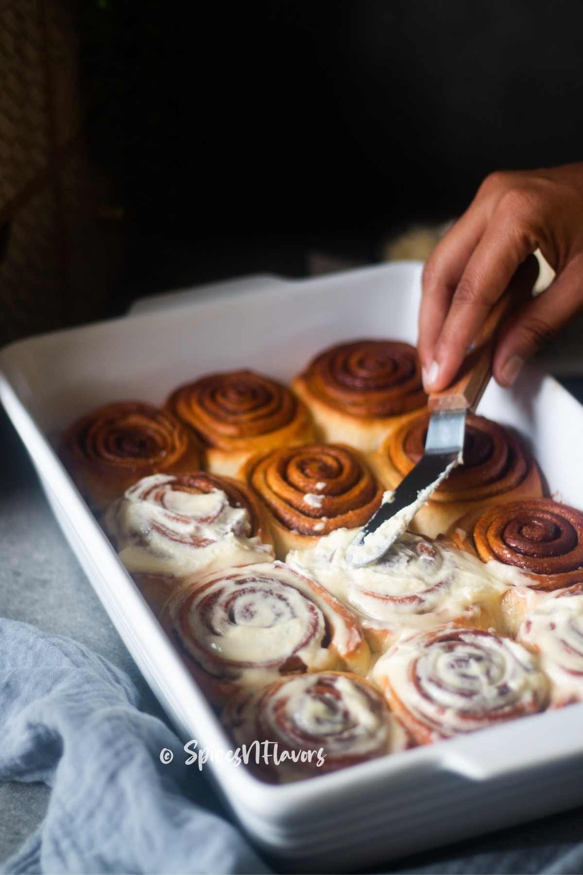 smear the icing on top of the rolls