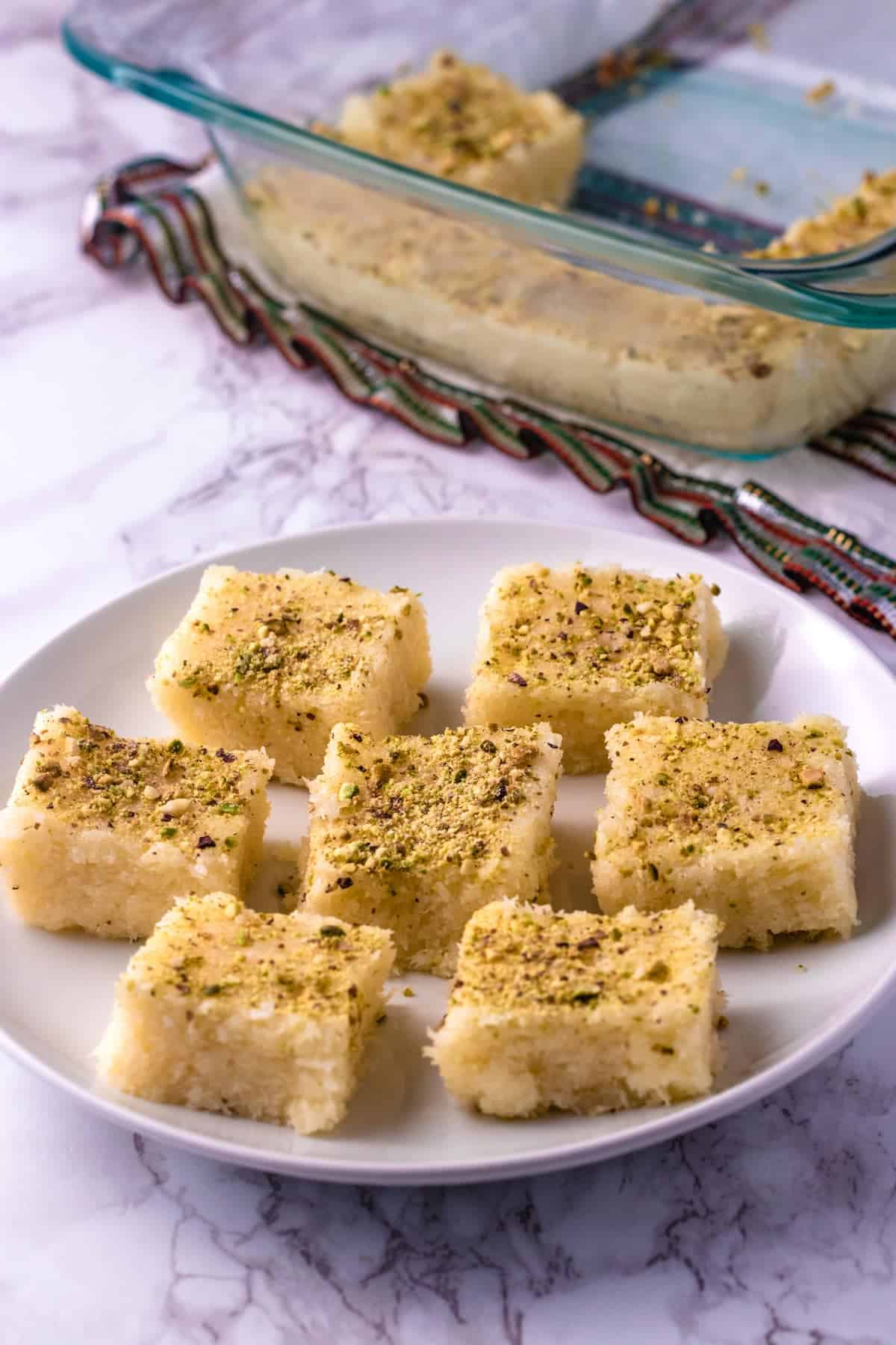 Coconut burfi placed on a white plate