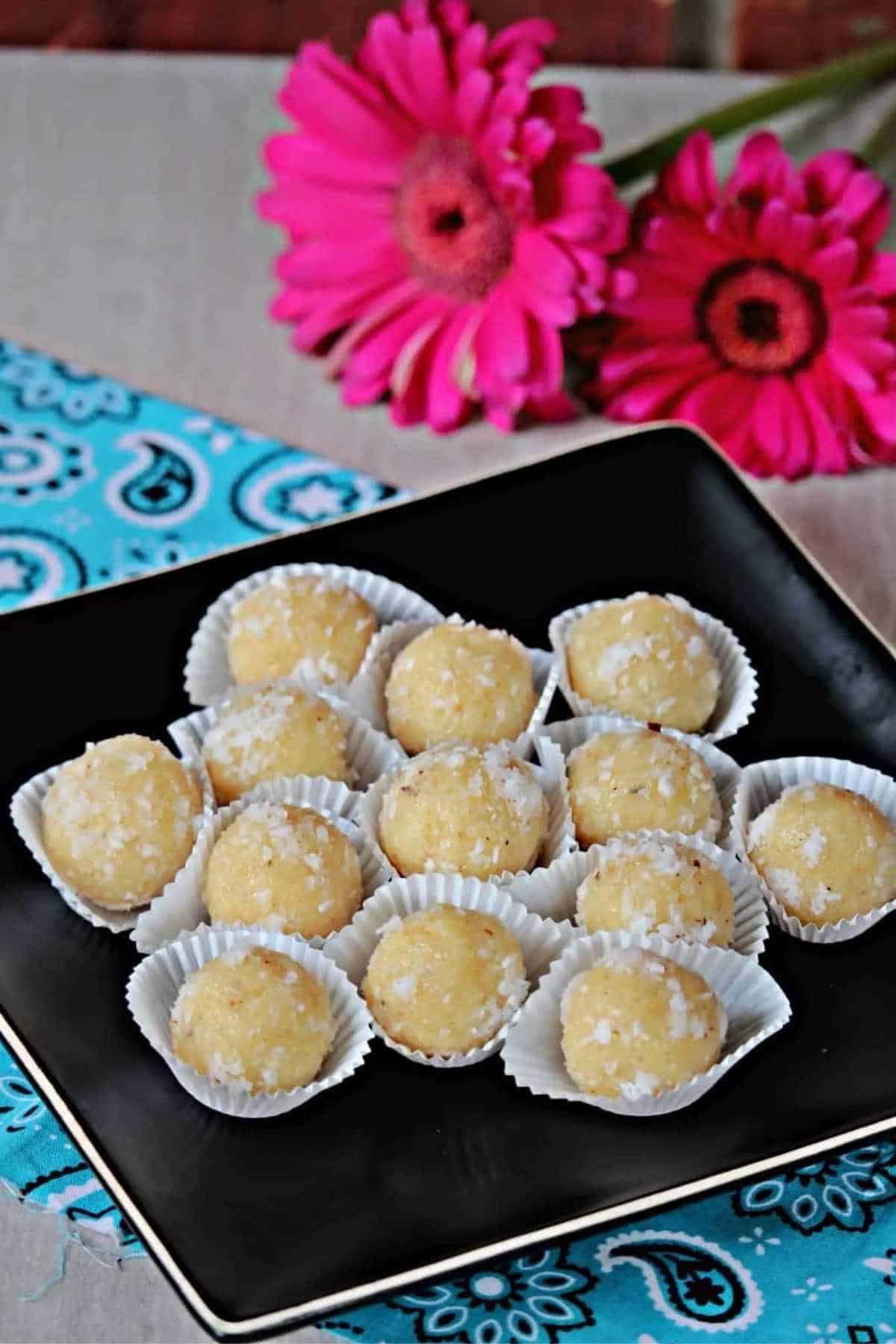 coconut laddu placed on a black plate