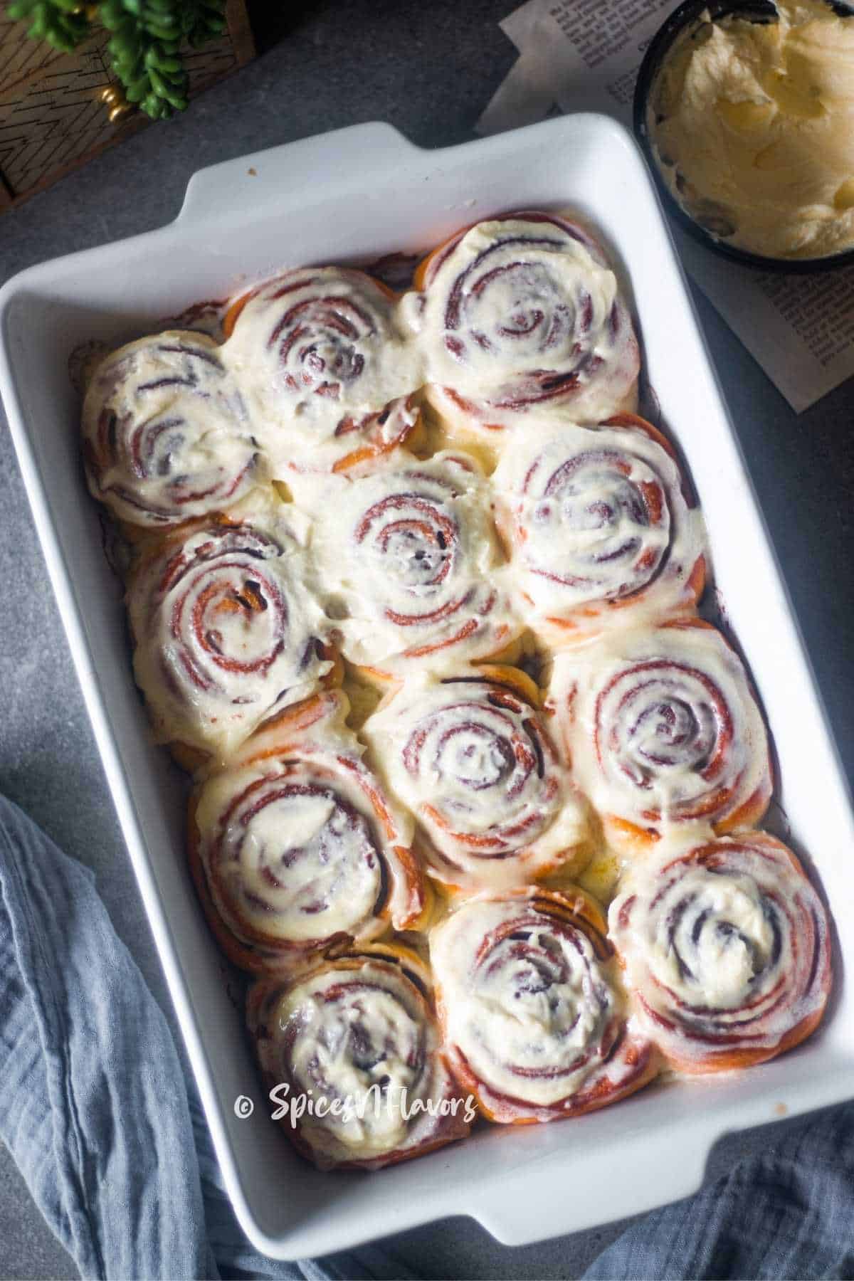 cinnamon rolls iced with the prepared icing on top