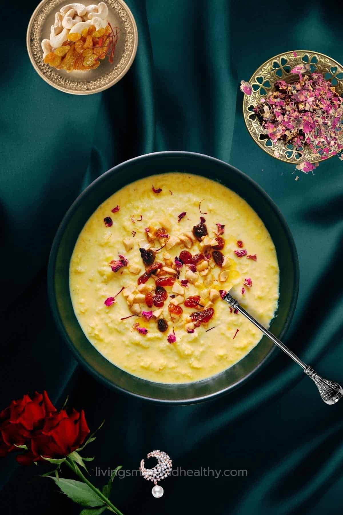 lauki ki kheer served in a big black bowl garnished with rose petals and nuts