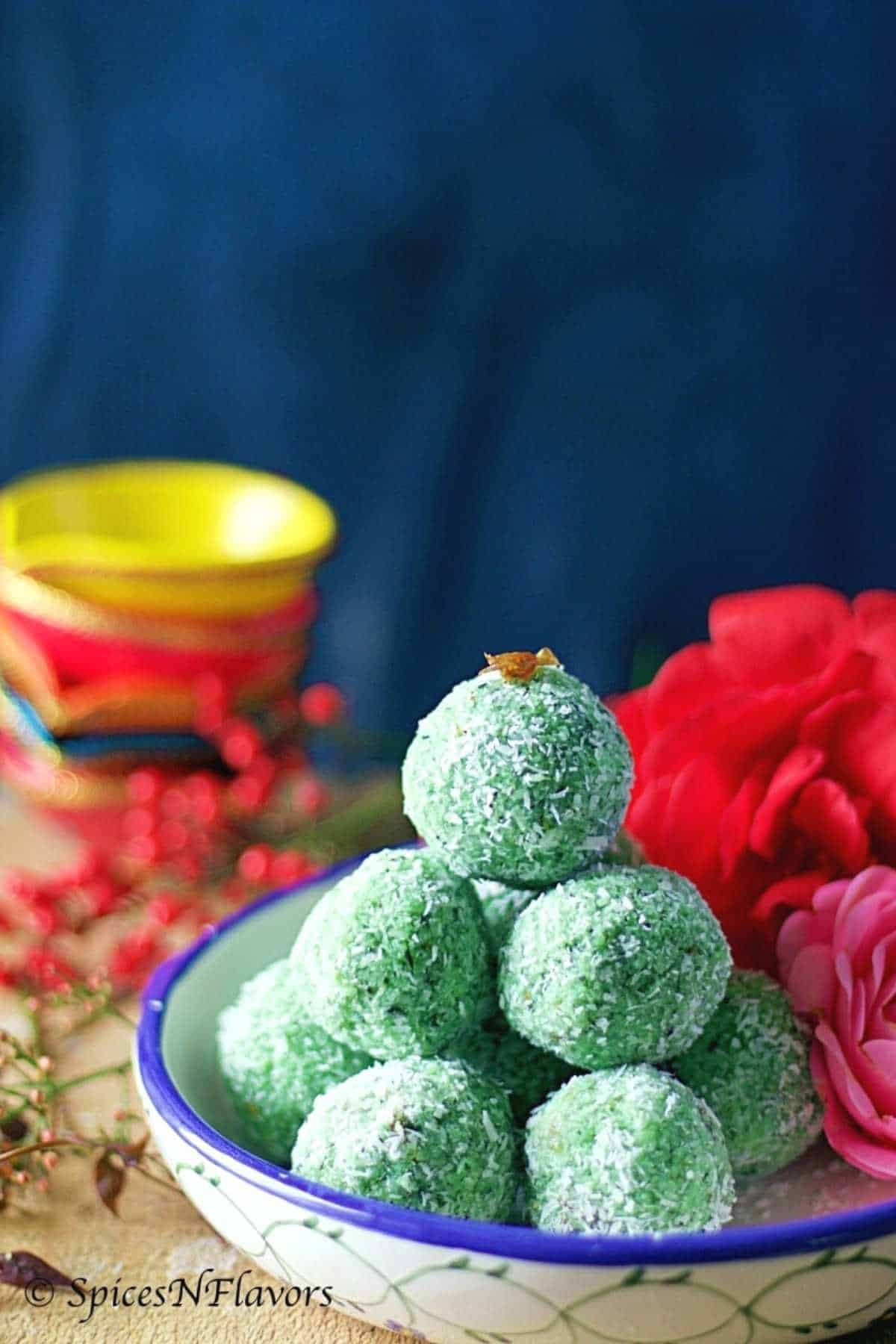 paan laddu stacked like a pyramid placed over a blue and white bowl